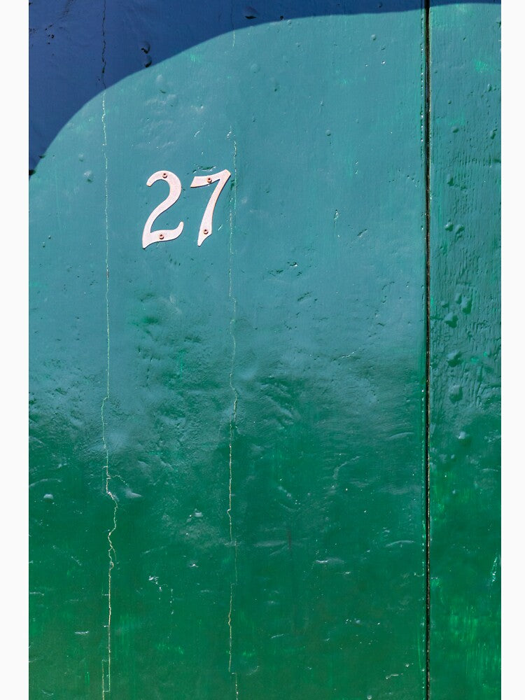 Vintage Green Door With White Number 27 And Weathered Wood Texture In Sunlight by Nmallia