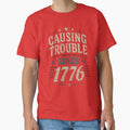 Causing Trouble Since 1776 – Funny Patriotic 4th of July Shirt | Vintage America 250 Independence Day Design by Diesel outlaw