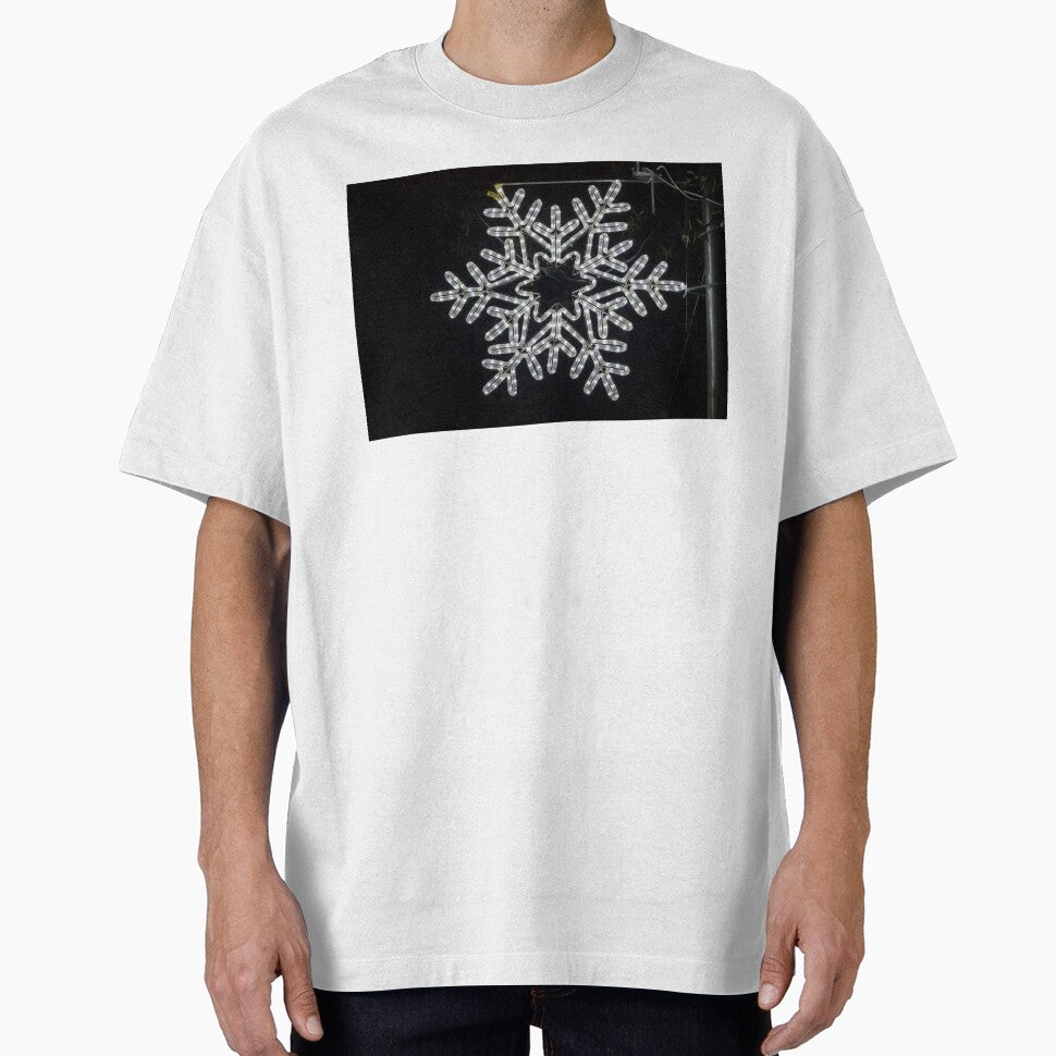 Illuminated Snowflake Holiday Light Decoration Hanging On Pole Against Dark Night Sky by Nmallia